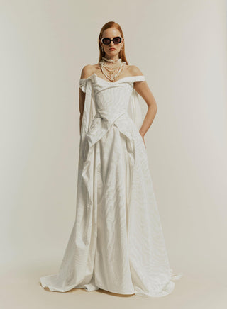 Front view of the Tabitha gown in white, styled with black glasses, showcasing a chic and modern look.