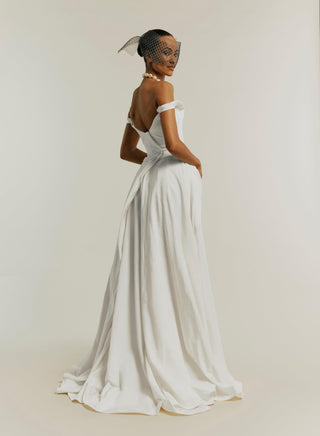 Side-back view of the Tabitha gown in white, highlighting the bias-cut circle skirt.