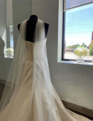 Designer bridal wrap with ethereal cascading tulle and refined shoulder framing, ideal for formal gowns and elegant weddings