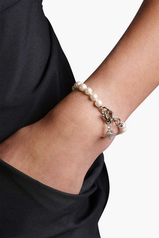 Model showcasing the Aleksa bracelet by Vivienne Westwood in platinum, adorned with baroque pearls and sparkling crystals.