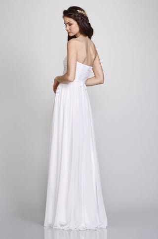 Maxi formal dress featuring sleek strapless neckline, elegant embroidery, and graceful draped skirt